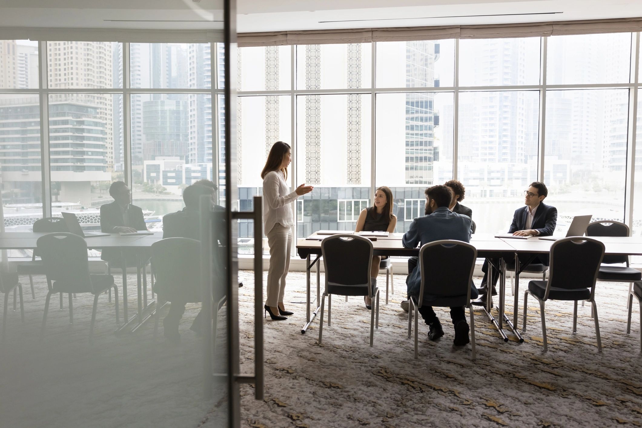Multiethnic business team in conversation around a meeting table